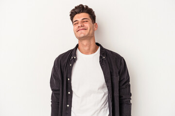 Fototapeta premium Young caucasian man isolated on white background laughs and closes eyes, feels relaxed and happy.