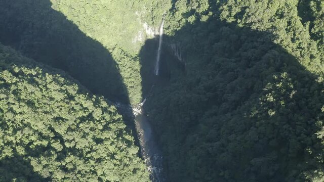 Aerial view of Cascade de La Grande Ravine, a beautiful waterfall among the wild mountains near Saint Benoit, Reunion.