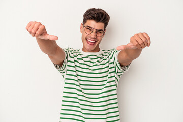 Fototapeta premium Young caucasian man isolated on white background raising both thumbs up, smiling and confident.