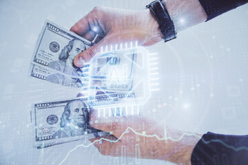 Multi exposure of technology drawing hologram and us dollars bills and man hands. Data concept