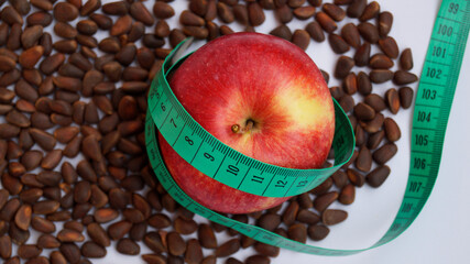 red apple with measuring tape