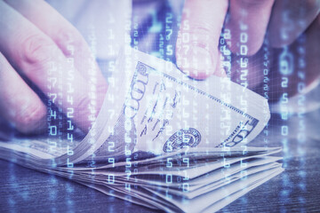 Double exposure of technology drawing hologram and us dollars bills and man hands. Data concept