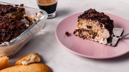 High angle view of gourmet Tiramisu italian with a cup of coffee and a piece of cake served with copy space. Classic italian recipe.