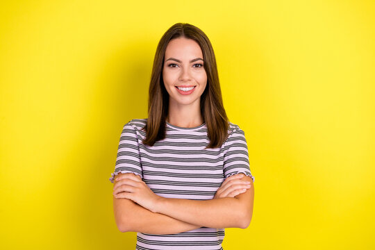 Photo of boss young brunette lady crossed arms wear striped t-shirt isolated on yellow background