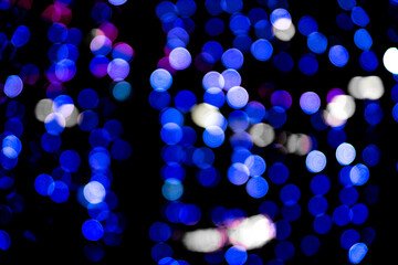 Christmas bokeh overlay background. Blue light on the black background. New Year, festive atmosphere