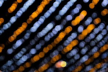 Christmas bokeh overlay background. colored garland blurry light on the black background. New Year, festive atmosphere