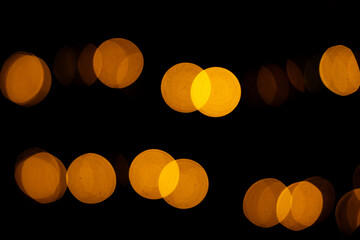Christmas bokeh overlay background. Golden blurry lights on the black background. New Year, festive atmosphere