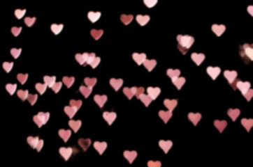 Valentines day bokeh overlay background. Pink hearts on the black background. romantic, festive atmosphere