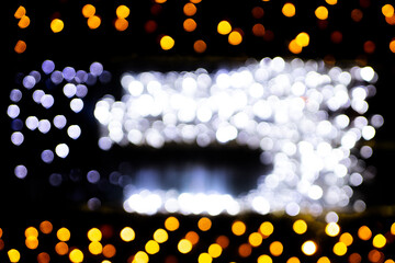 Christmas bokeh overlay background. Golden light i the window on the black background. New Year, festive atmosphere
