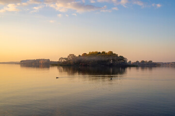 Obraz premium Beautiful island with fog at sunset. Summer landscape