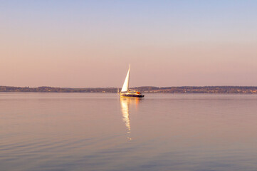 Beautiful water landscape with yacht and sail at sunset