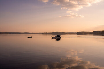 Beautiful water landscape with boat at sunset