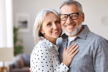 Beautiful smiling senior family couple husband and wife looking at camera with love
