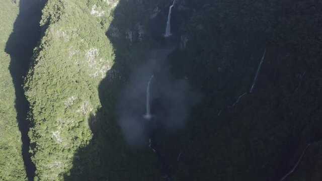 Aerial view of Cascade de La Grande Ravine, a beautiful waterfall among the wild mountains near Saint Benoit, Reunion.