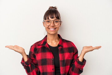 Young mixed race woman isolated on white background  makes scale with arms, feels happy and confident.