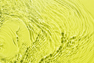 Water spills on a light green yellow background. Beautiful bursts and glare. Summer mood. Minimal style. Natural sunlight and shade. Backdrop for cosmetic ideas