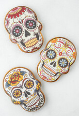 abstract background with gingerbread in the form of painted skulls for day of the dead or halloween