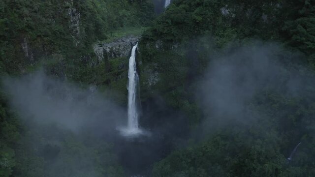 Aerial view of Cascade de La Grande Ravine, a beautiful waterfall among the wild mountains near Saint Benoit, Reunion.