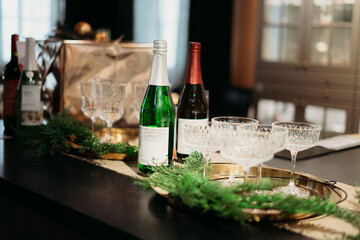 decoration of the New Year's table, champagne, wine, flowers, gifts