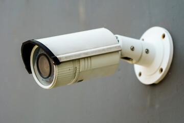 white cctv camera mounted on the wall