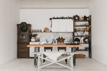 New Year's kitchen interior design in a light Scandinavian style with a table and decoration made of natural materials