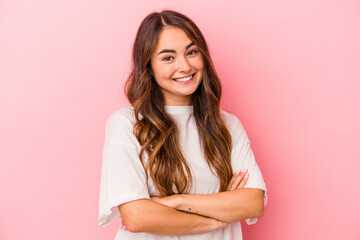 Young caucasian woman isolated on pink background happy, smiling and cheerful.