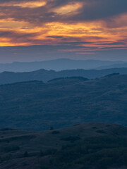 the curved hills seen to the sunset