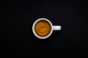 Behind every successful person is a substantial amount of coffee. Table top view of a white cup of...