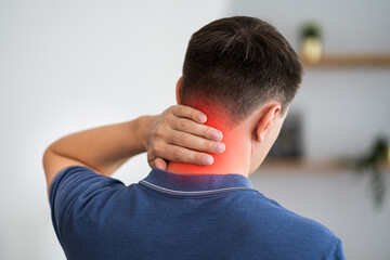 Neck pain, man suffering from ache at home