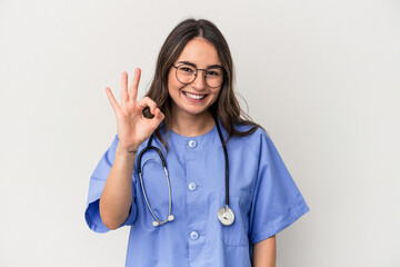 Young caucasian nurse woman isolated on white background cheerful and confident showing ok gesture.