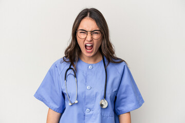 Young caucasian nurse woman isolated on white background screaming very angry and aggressive.