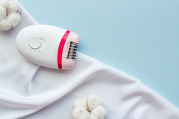 White epilator with cotton flowers for hair removal, top view