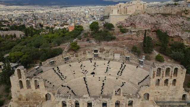 Aerial drone video from iconic ancient theatre of Herodes Atticus near Acropolis hill, Athens historic centre, Attica, Greece                              