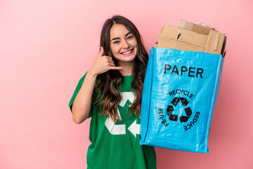 Young caucasian woman recycled paper isolated on pink background showing a mobile phone call gesture with fingers.