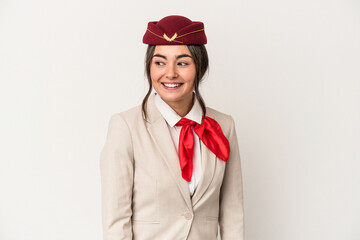 Young caucasian stewardess woman isolated on white background looks aside smiling, cheerful and pleasant.