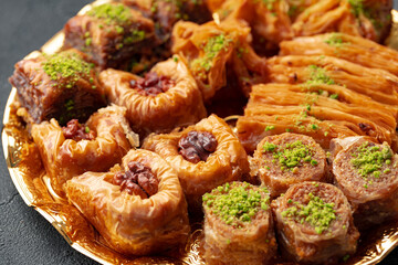 Delicious baklava dessert in oriental setting on black background