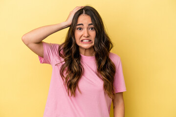 Young caucasian woman isolated on yellow background being shocked, she has remembered important meeting.