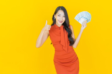 Portrait beautiful young asian woman smile with a lot of cash and money