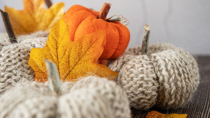 Hand made fabric pumpkin over grey knitted blanket for fall home decoration