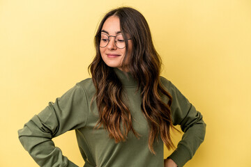 Young caucasian woman isolated on yellow background dreaming of achieving goals and purposes