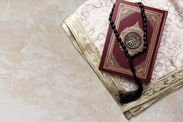 Holy Quran book with arabic calligraphies translation and Rosary beads
