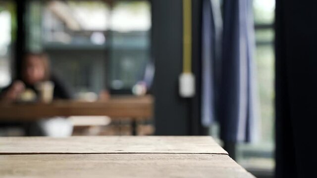 Wooden table at the cafe with a dark curtain
