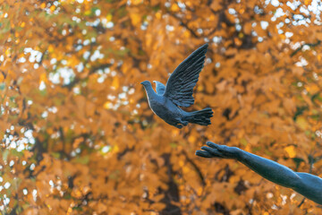 Bronze sculpture of a dove flying into the sky