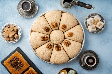 Top view of Turkish sweets and turkish coffee on light blue background