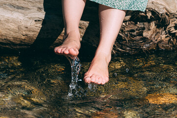 川の水を足に付ける女性の足元
