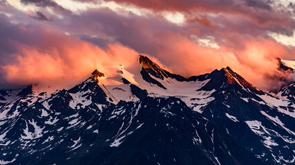 Dramatic orange clouds over the Wilder Freiger mountain in austrian Stubai Alps.