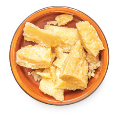 Pieces of parmesan cheese in a clay rustic bowl  isolated on white background.