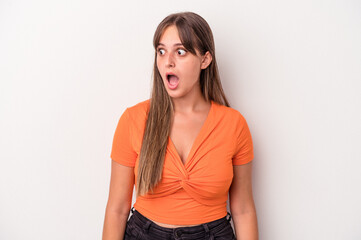 Young caucasian woman isolated on white background being shocked because of something she has seen.