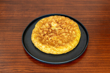 Traditional Spanish potato omelette served in a tapas restaurant