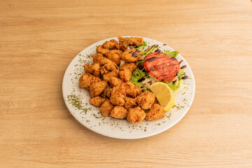 typical Spanish tapas restaurant recipe. Fish dish, cazon, marinated, breaded and fried in olive oil on wooden table